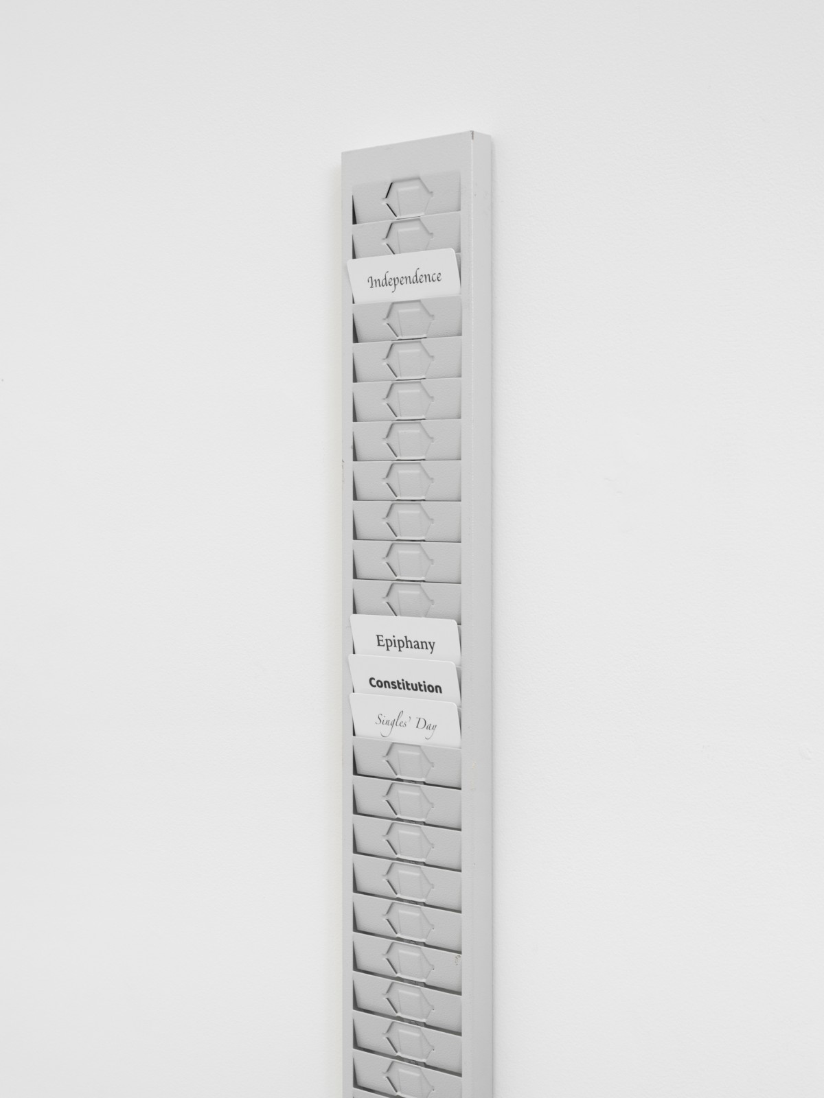 Jiajia Zhang, Common People, 2023, metal cardholders, cards with names of public holidays, 82 x 11 x 2 cm